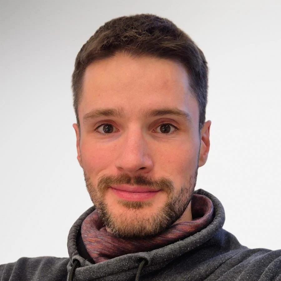 A man with short brown hair, a well-groomed beard, and a hoodie smiles for his AI ID photos. A man with short brown hair, a well-groomed beard, and a hoodie smiles for his AI ID photos.