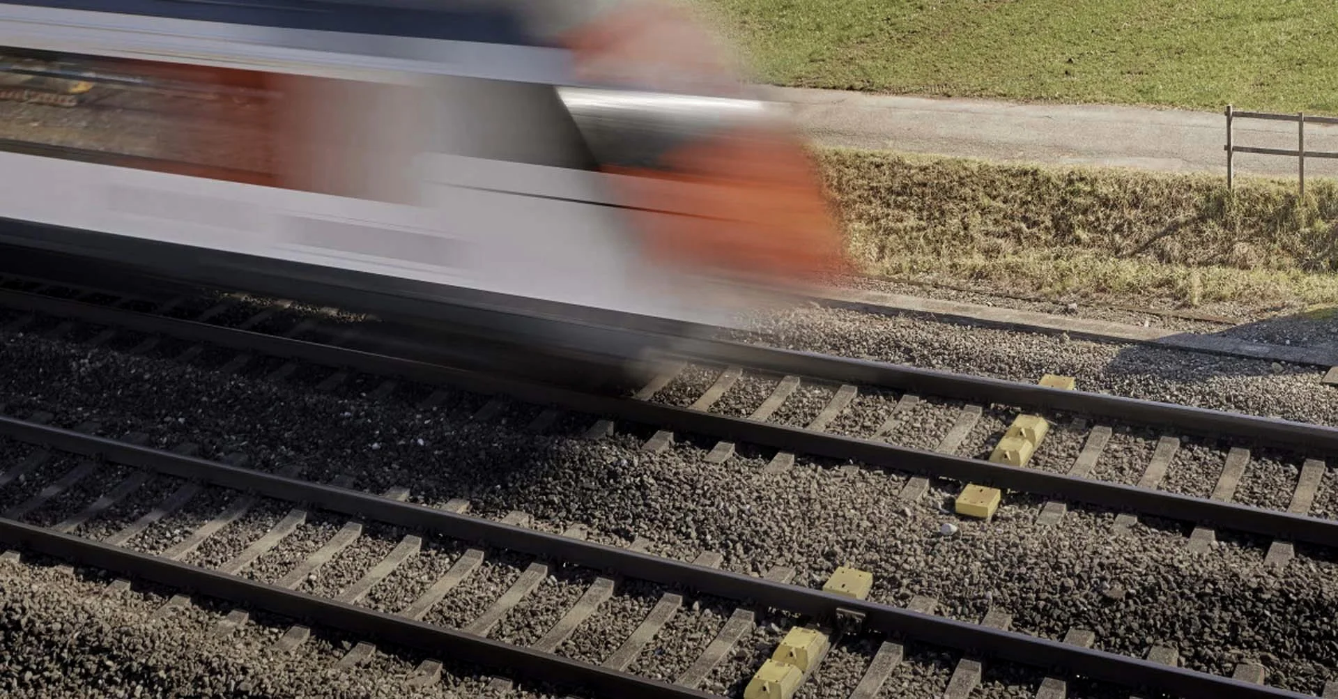 A fast-moving train speeds past on the tracks, conveying an impression of the speed of high-performance computing.