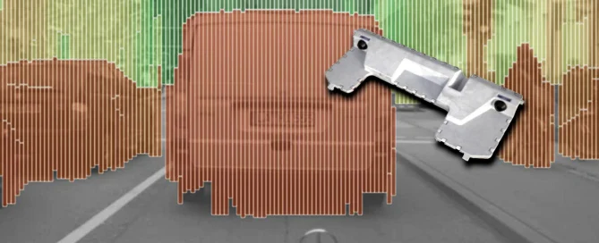 Car on the road with a colored graphic overlay, measurement technology in focus, and a metal part in the foreground.