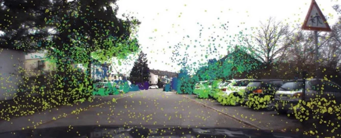 View through a car windshield with measurement points, parked cars, and a triangular traffic sign in the foreground.